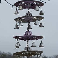 Low angle view of illuminated lanterns hanging against sky