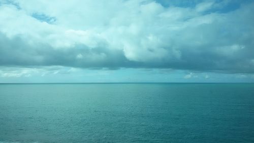 Scenic view of sea against storm clouds