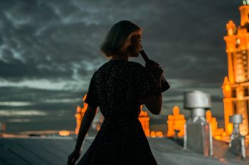 WOMAN STANDING AT NIGHT