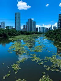 Reflection of buildings in lake against sky