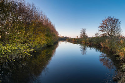 Scenic view of lake against clear sky during autumn