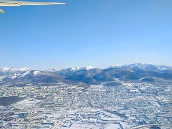 Aerial view of cityscape against clear blue sky