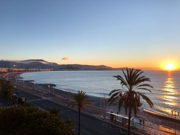 Scenic view of sea against clear sky at sunset