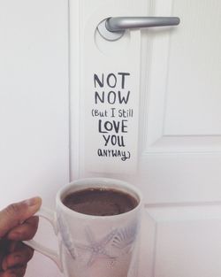 Close-up of hand holding coffee cup