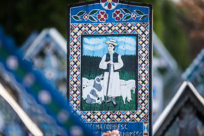 Close-up of text on cross