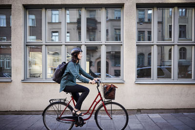 Man riding bicycle on city street