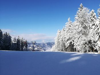 Scenic view of snowcapped mountains against clear blue sky