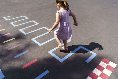 Girl playing hopscotch at playground