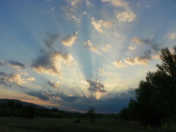 Scenic view of field against cloudy sky