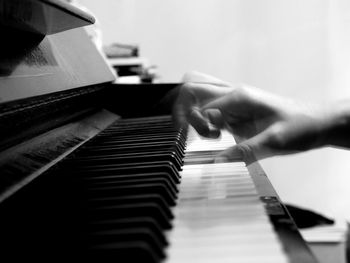 Close-up of hands playing piano