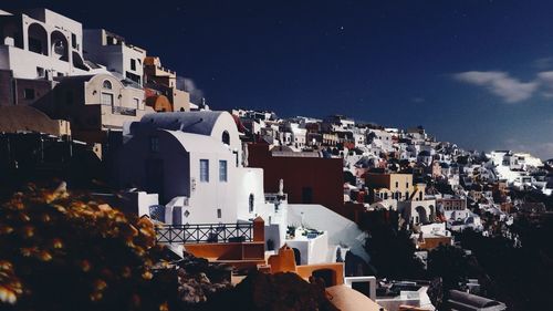 Buildings in town against sky at night