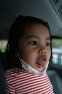 Portrait of cute girl in car