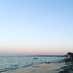 Scenic view of sea against clear sky during sunset