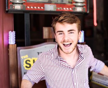 Portrait of smiling young man at restaurant