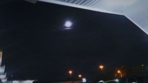 Low angle view of illuminated lights at night