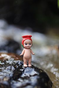 Close-up of figurine toy on rock