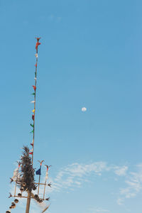 Low angle view of flag against blue sky