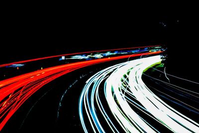 Light trails on road in city at night