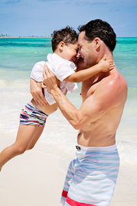 Father and son playing at the beach in the caribbean