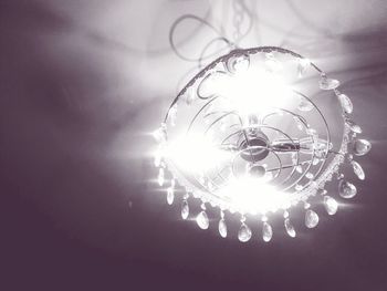 Low angle view of electric lamp against sky