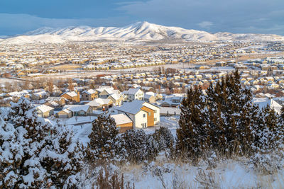 High angle view of townscape and snowcapped mountain