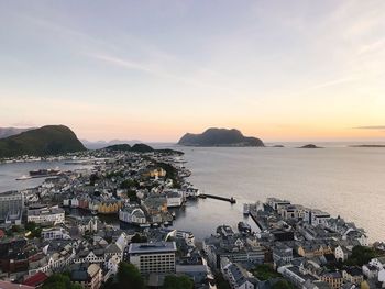 High angle view of city by sea against sky