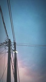 Low angle view of electricity pylon against sky