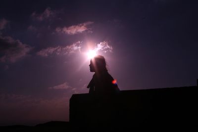 Low angle view of silhouette man against sky at night