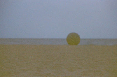 Sand on beach against sky