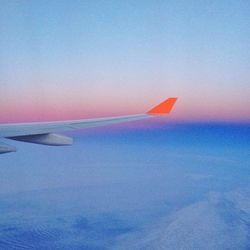 Cropped image of airplane flying over sea