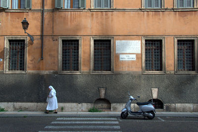 Side view of woman cycling on street