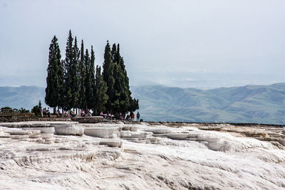 People on mountain against sky