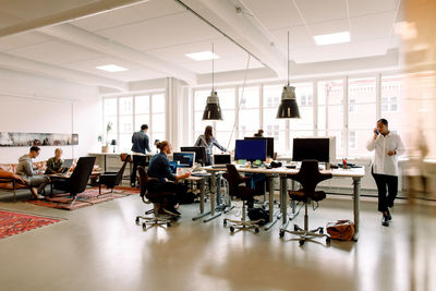 Male and female entrepreneurs working in creative office