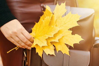 Close-up of woman holding yellow paper