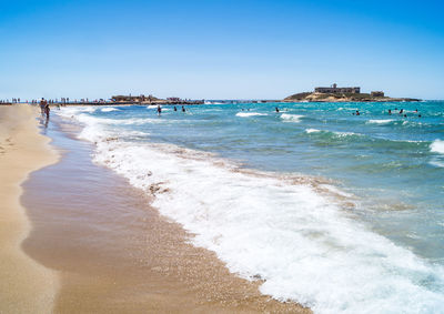 Scenic view of beach against clear sky