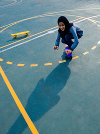 High angle view of boy walking on road