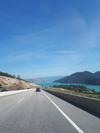 View of highway against blue sky