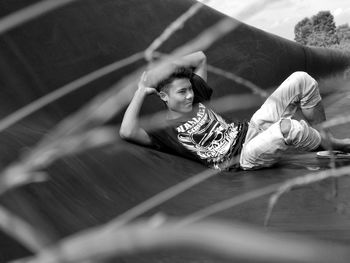 Smiling young man lying on floor