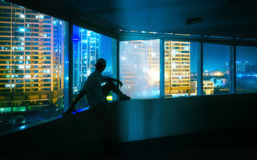 Man sitting in glass window