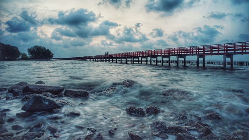 Bridge over sea against sky