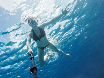 Woman swimming undersea