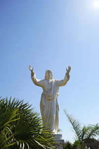 Low angle view of statue against clear blue sky