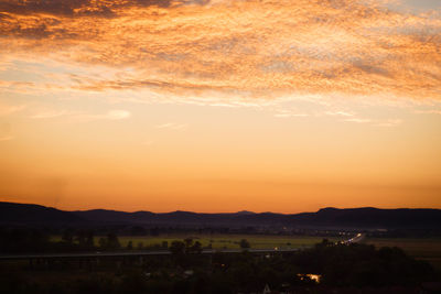 Scenic view of silhouette landscape against sky during sunset