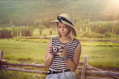 Portrait of young woman drinking water