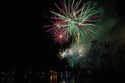 Low angle view of firework display in sky at night