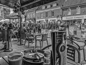 People standing on chairs in city