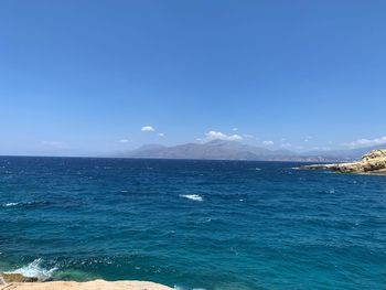 Scenic view of sea against clear blue sky