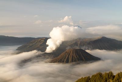 Smoke emitting from volcanic mountain against sky