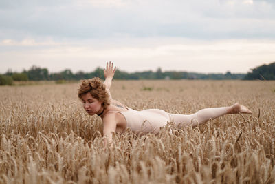 Woman with arms raised on field