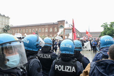 Group of people in city against clear sky